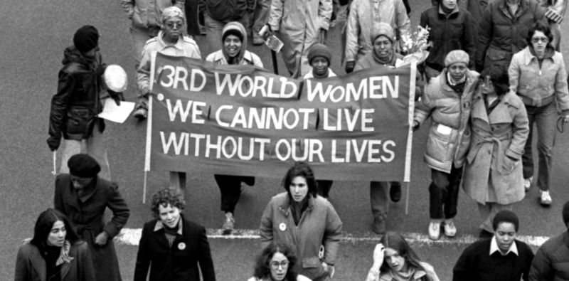 Photograph of a protest of the Combahee River Collective, with women carrying a banner reading '3rd world women we cannot live without our lives'